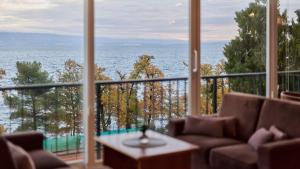 a view of the ocean from a room with a large window at Hotel Lovran in Lovran