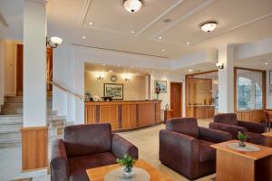 a living room with two chairs and a table at Hotel Lovran in Lovran