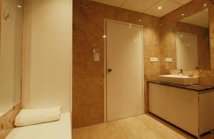 a bathroom with a sink and a mirror at ADB Kanvas, Lataguri in Lataguri