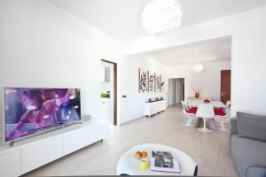 a living room with a large flat screen tv at Santerra - San Jose in Cala Bassa