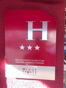 a red box with the h sign on it at Le CESAR HOTEL in Royat