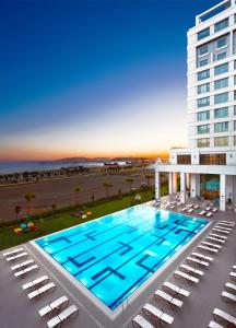 an overhead view of a large swimming pool in front of a building at The Green Park Pendik in Istanbul