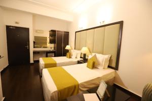 Postel nebo postele na pokoji v ubytování Hotel Capitol Hills - Greater Kailash Delhi