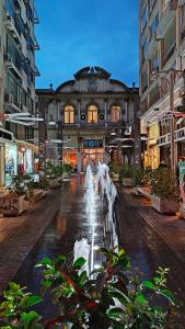 a building with a fountain in the middle of a street at New deluxe studio 4 downtown Thessaloniki- Fully equiped in Thessaloniki
