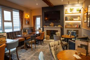 a restaurant with tables and chairs and a fireplace at Duke of York in Whitby