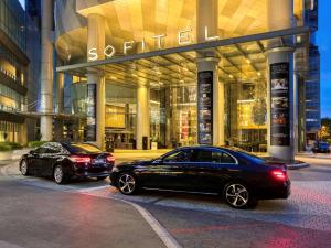 two cars parked in front of a shopping center at Sofitel Kuala Lumpur Damansara in Kuala Lumpur