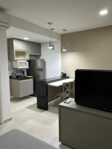 a kitchen with a large kitchen with a counter top at Flat Duo JK. Lindo e completo in Sao Jose do Rio Preto