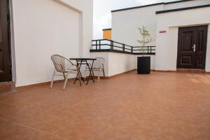 a patio with a table and chairs in a building at Executive Large Room with Ensuite in Accra