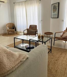 a living room with a couch and tables and chairs at Appartement Casa Lina Lagos vue mer in Lagos