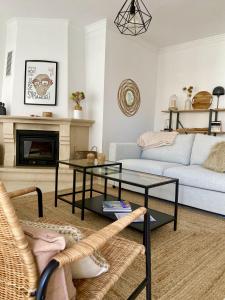 a living room with a couch and a table at Appartement Casa Lina Lagos vue mer in Lagos