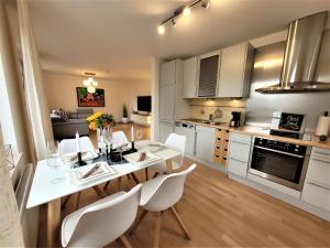 a kitchen with a white table and white chairs at Winterberg Appartement 21121 in Winterberg