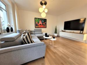 a living room with a couch and a flat screen tv at Winterberg Appartement 21121 in Winterberg