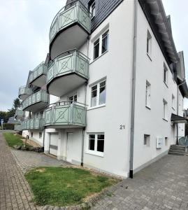 an apartment building with balconies on the side of it at Winterberg Appartement 21121 in Winterberg