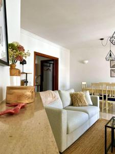a living room with a couch and a table at Appartement Casa Lina Lagos vue mer in Lagos