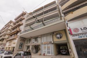 a building with cars parked in front of it at SUGARAKIS B in Volos