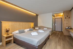Postel nebo postele na pokoji v ubytování Hotel Piandineve