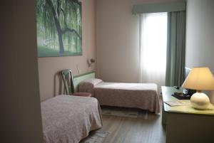 Postel nebo postele na pokoji v ubytování Hotel Valbrenta