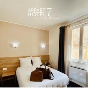 Katil atau katil-katil dalam bilik di Appart' hôtel 7 sensation