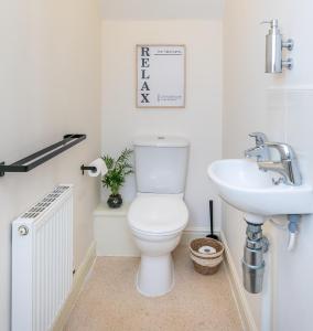 a bathroom with a toilet and a sink at The Fusiliers in Leyland