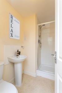 a bathroom with a sink and a toilet and a shower at The Fusiliers in Leyland