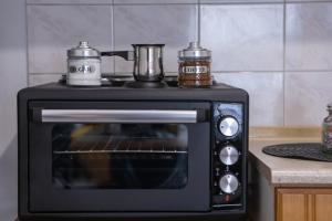 a stove top oven with two pots on top of it at SUGARAKIS B in Volos