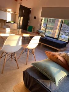 a living room with a dining room table and chairs at La Reserva in Villa Parque Siquiman