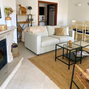 a living room with a couch and a fireplace at Appartement Casa Lina Lagos vue mer in Lagos