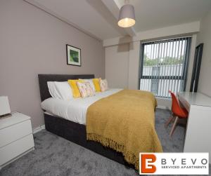 a bedroom with a bed and a desk and a window at ByEvo 6 Brabloch - perfect for contractors - Close to GLA in Paisley