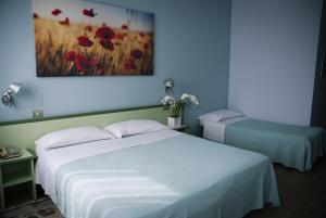 Postel nebo postele na pokoji v ubytování Hotel Valbrenta