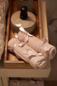 a couple of towels on a wooden tray at Dandy Villas Dimitsana - a family ideal charming home in a quaint historic neighborhood - 2 fireplaces for romantic nights in Dimitsana