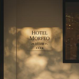 a sign for a hotel morocco on a glass wall at Hotel Morfeo in Milan