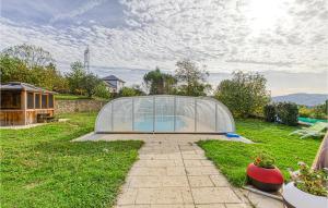 a greenhouse in the middle of a yard at Awesome Home In Castelnau-d-mandailles With Outdoor Swimming Pool, Wifi And 2 Bedrooms in Castelnau-de-Mandailles