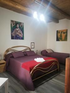 a bedroom with a red bed and a couch at B&B Parva Domus in Lamezia Terme