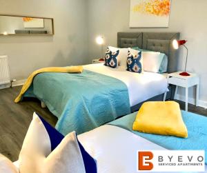 a bedroom with two beds with blue and white at ByEvo Almar Villa - Comfy Contractor or Large groups property in Glasgow