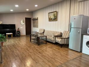 a living room with a couch and a refrigerator at Bright Guesthouse in the center of Yerevan! in Yerevan