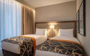 twee bedden naast elkaar in een hotelkamer bij Clayton Hotel Glasgow City in Glasgow