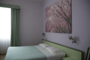 Postel nebo postele na pokoji v ubytování Hotel Valbrenta