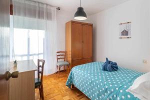 1 dormitorio con cama, escritorio y silla en Hermanos Pinzón Apartamento, en Zamora