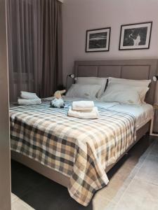 a teddy bear sitting on top of a bed at Borovete Mountain Luxury in Borovets