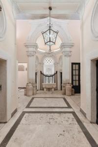 a large room with a chandelier in a building at A World Aparts - 21 T. Argentina in Rome