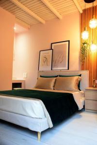 sypialnia z dużym łóżkiem i 2 zdjęciami na ścianie w obiekcie maison jamouri w mieście Kríni