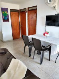 a dining room with a white table and chairs at Cabaa De Descanso, Isla De Bar - Cartagena - Rest Cabin, Baru Island -Bolivar in Playa Blanca