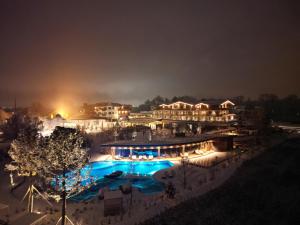 a resort with a swimming pool at night at Laschenskyhof Hotel & Spa in Wals