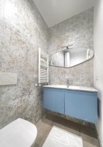 a bathroom with a blue sink and a toilet at Cà Laguna Lido in Venice-Lido +22 photos