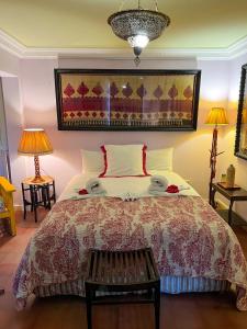 a bedroom with a large bed and two lamps at Aux 3 Portes in Tangier