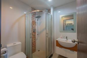 y baño con ducha, aseo y lavamanos. en Studio Cape Panwa Ocean Front Partial SeaviewSwimming Pool View with Super WIFI, en Ban Ao Makham