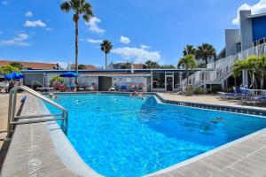 a swimming pool with blue water in a resort at Madeira Beach Yacht Club 343 #G in St Pete Beach