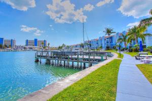 a walkway next to a body of water with buildings at Madeira Beach Yacht Club 343 #G in St Pete Beach