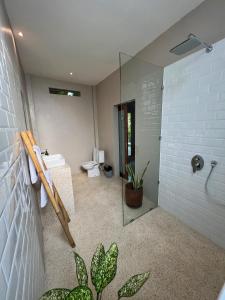 a bathroom with a shower and a sink and a toilet at Anchor Bed & Bread in Kuta Lombok