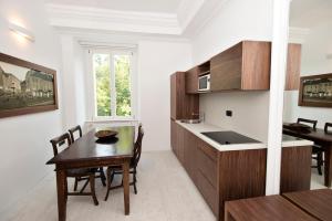 a kitchen and dining room with a table and a counter at Zois Apartments in Ljubljana